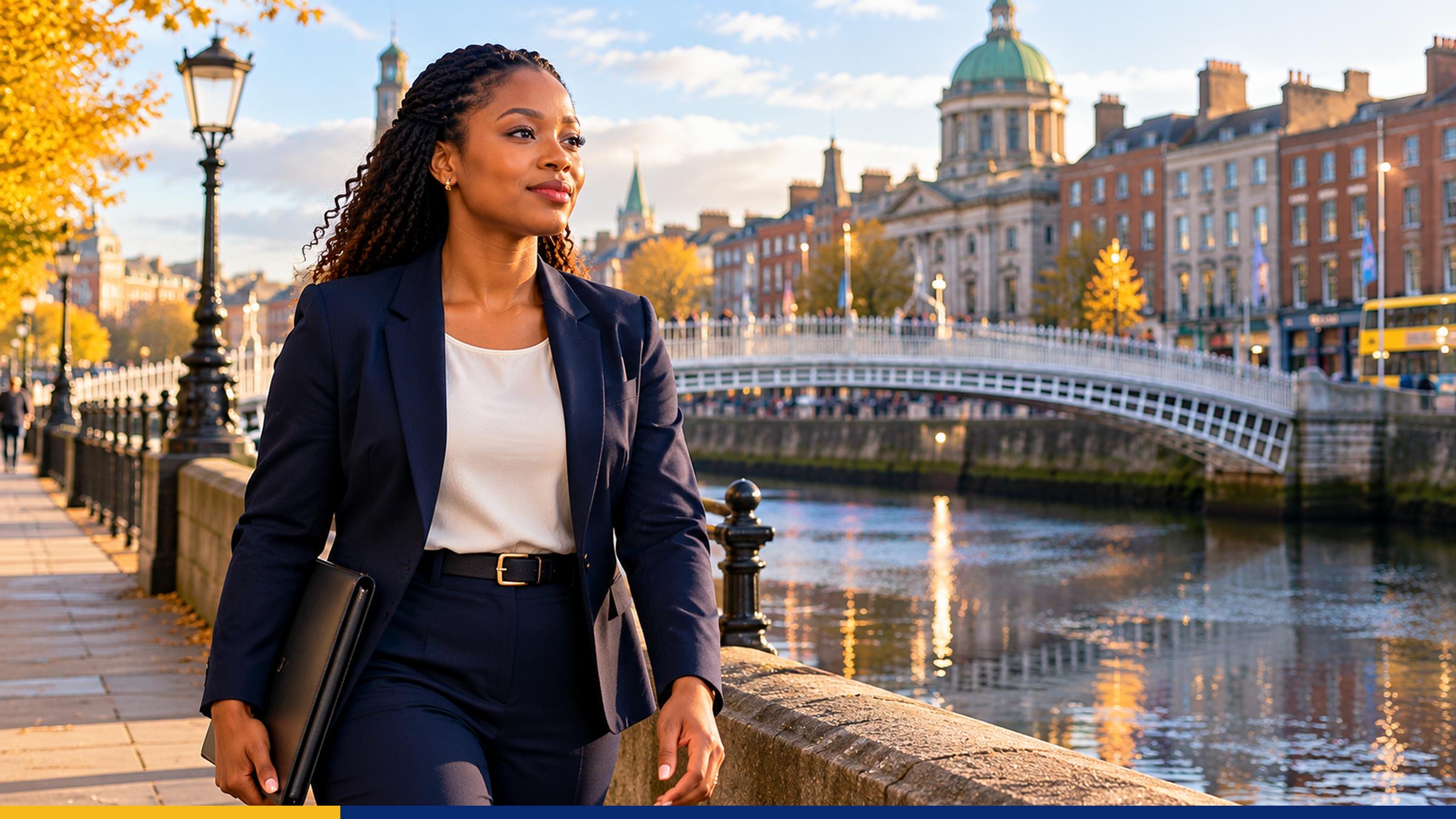 African business professional walking beside a historic bridge in Dublin, Ireland, carrying a portfolio